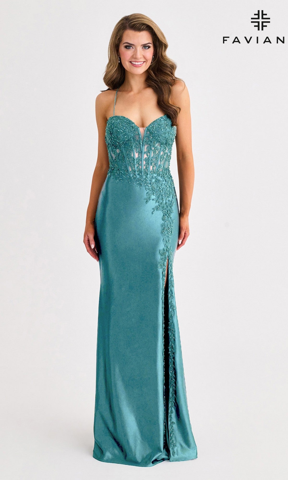 A woman wears the Faviana 11404 teal long prom dress featuring lace details, a corset bodice, thin straps, sweetheart neckline, and a thigh-high slit;